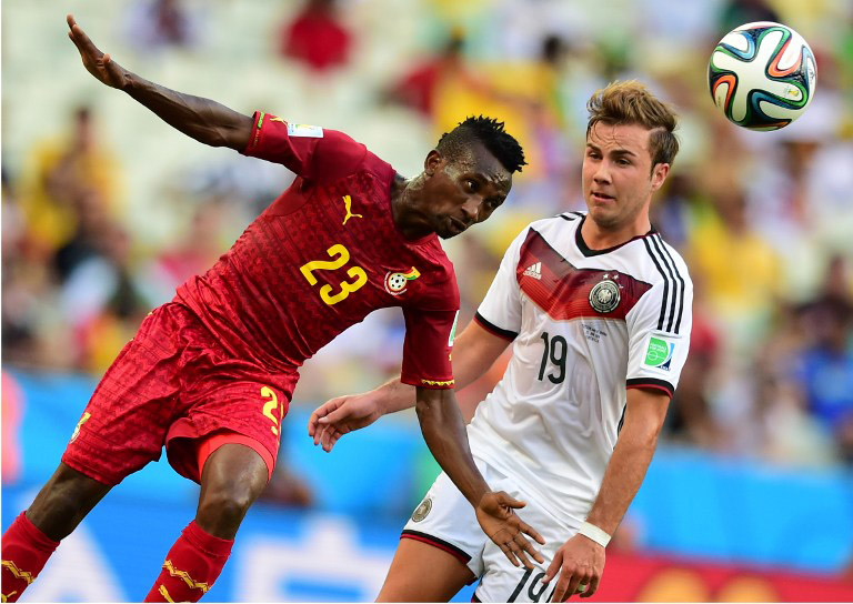 Ghana's Harrison Afful (L) kämpft gegen Mario Goetze beim Gruppe G Vorrundenspiel im Castelao Stadium in Fortaleza am 21.Juni 2014. AFP PHOTO / JAVIER SORIANO