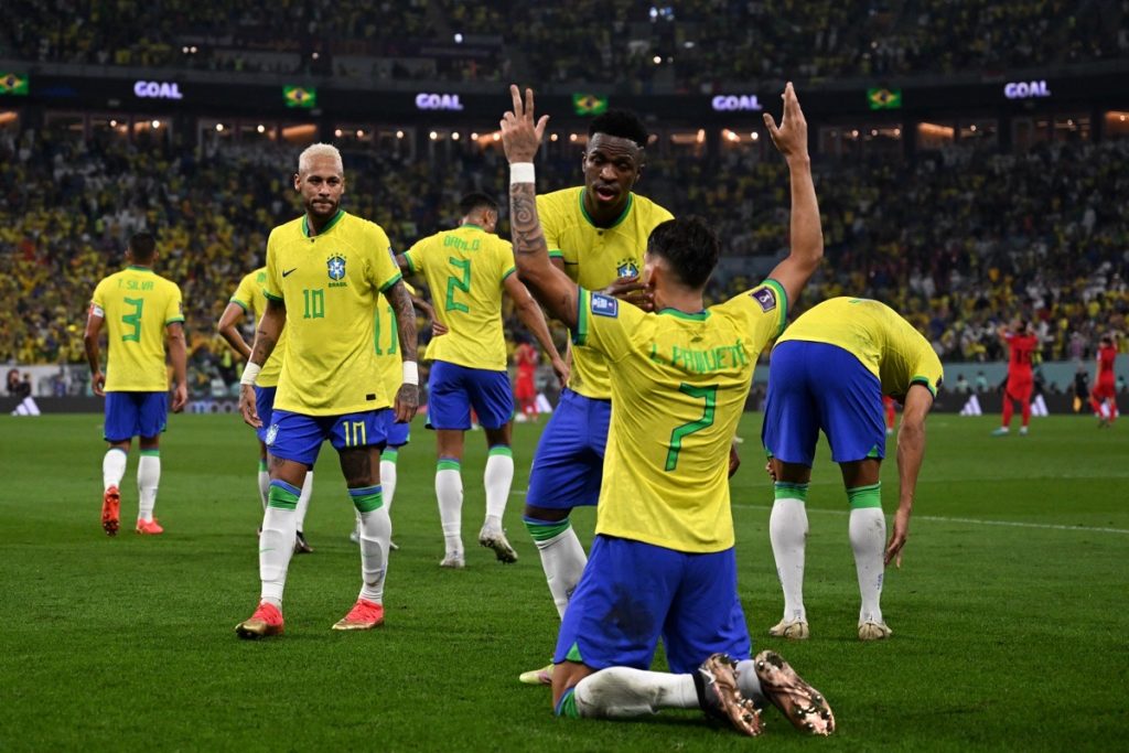 Der brasilianische Mittelfeldspieler Lucas Paqueta (Nr. 07) jubelt mit seinen Mannschaftskameraden nach dem vierten Tor seiner Mannschaft während des Achtelfinales der Fußballweltmeisterschaft Katar 2022 zwischen Brasilien und Südkorea im Stadion 974 in Doha am 5. Dezember 2022. (Foto von Pablo PORCIUNCULA / AFP)